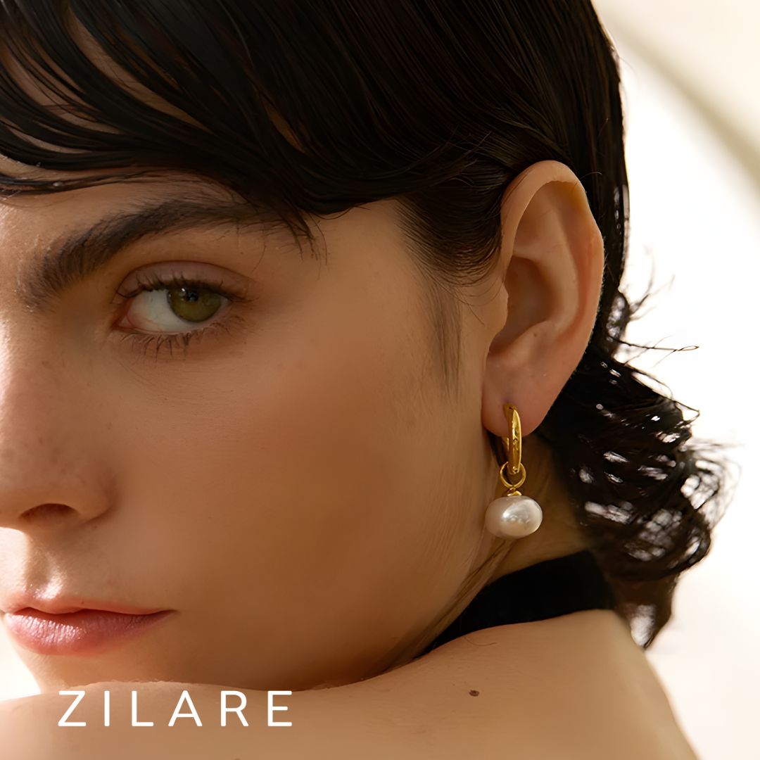 Aretes dorados con perla colgante bañados en oro 18k Paula