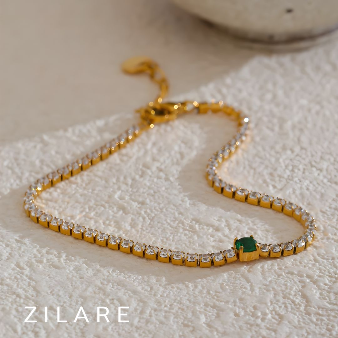 Pulsera dorada con piedras brillantes y detalle verde Florencia