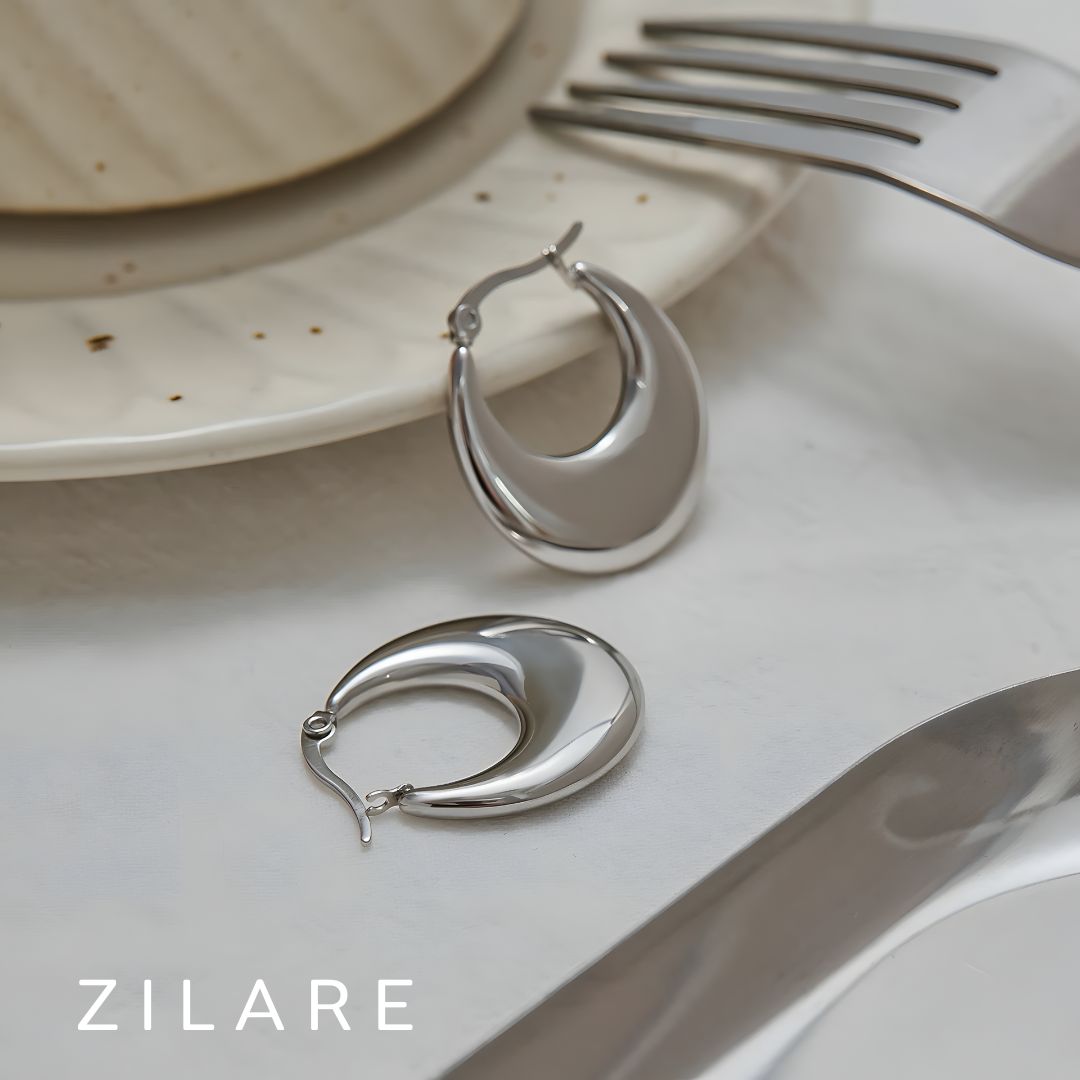 Aretes delicados acero inoxidable con diseño curvo Yamileth