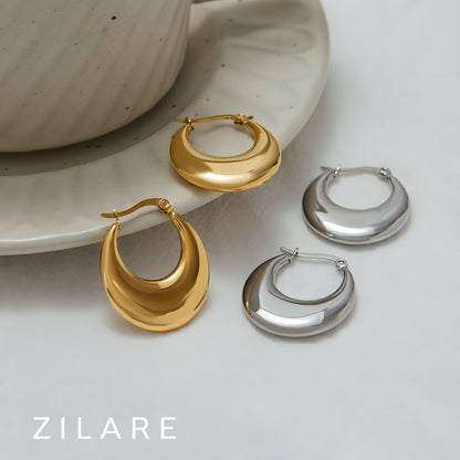 Aretes delicados acero inoxidable con diseño curvo Yamileth