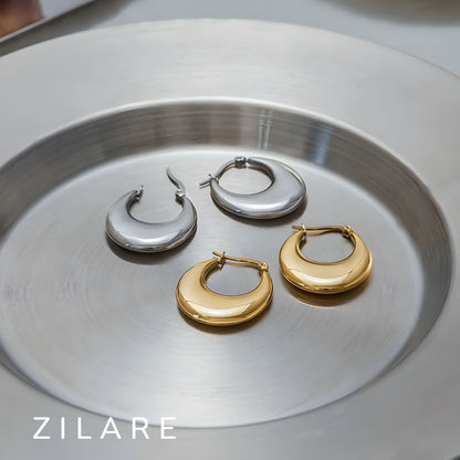 Aretes delicados acero inoxidable con diseño curvo Yamileth