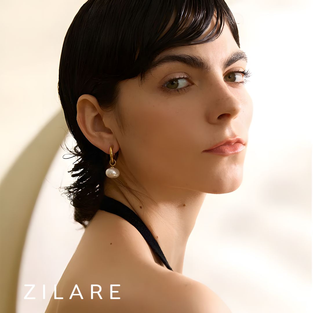 Aretes dorados con perla colgante bañados en oro 18k Paula