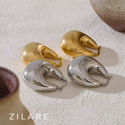 Aretes dorados voluminosos curvos bañados en oro 18k Sofía