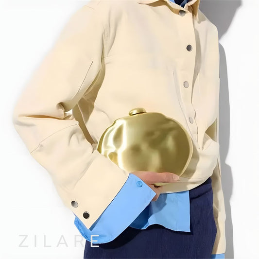 Bolsa de mano mujer dorada con cadena y diseño rígido Dora