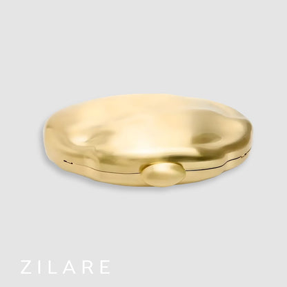 Bolsa de mano mujer dorada con cadena y diseño rígido Dora