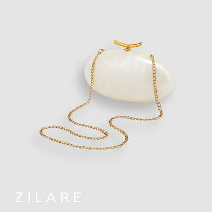 Bolsa de mano marfil nacarado con cierre dorado Marbella