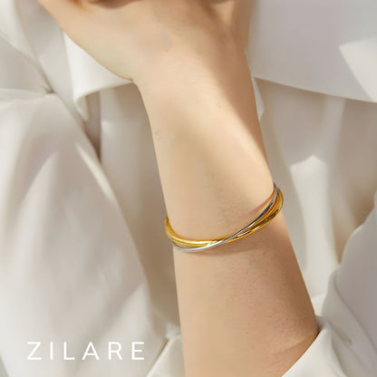 Pulsera Dorada y Plateada Cruzada Bañada en Oro 18k Emilia